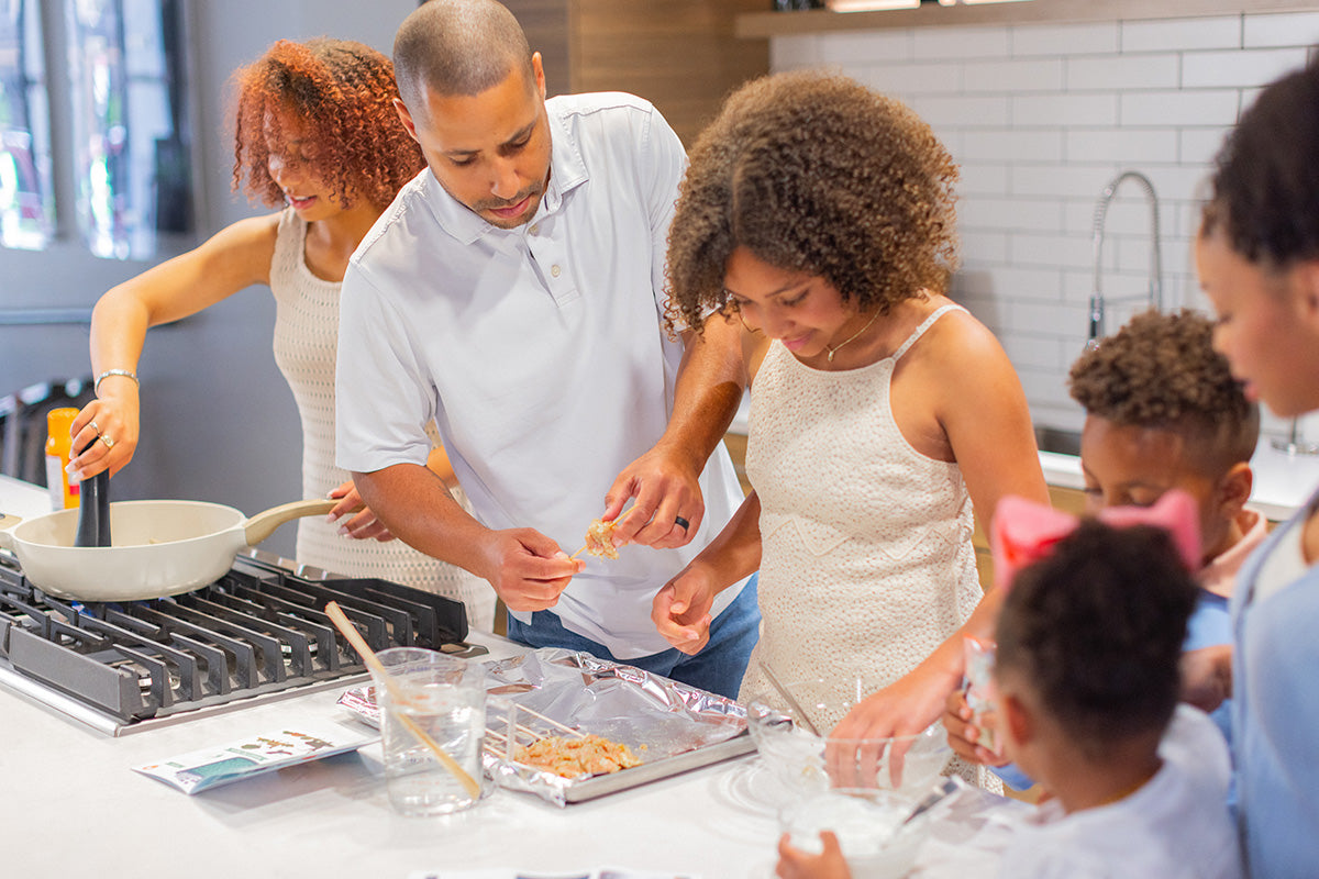 family cooking together in kitchen