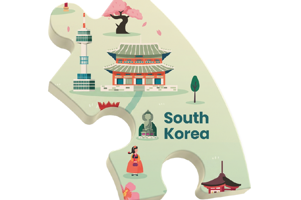 A single puzzle-piece-shaped sticker or plaque featuring a stylized illustration of South Korea, including a temple, cherry blossom tree, tower, traditional dancer, and the text 'South Korea' on a white background.