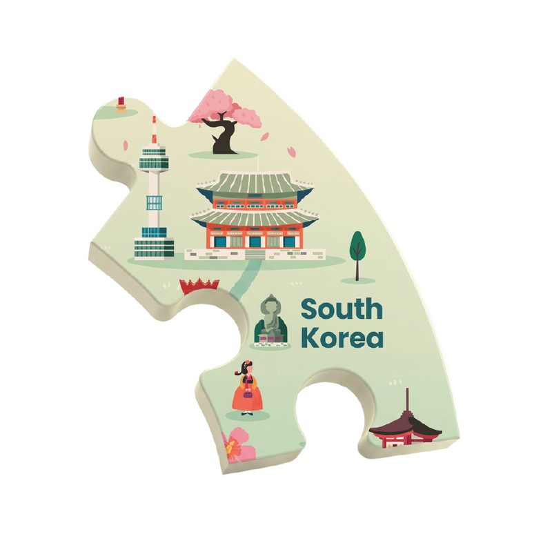 A single puzzle-piece-shaped sticker or plaque featuring a stylized illustration of South Korea, including a temple, cherry blossom tree, tower, traditional dancer, and the text 'South Korea' on a white background.