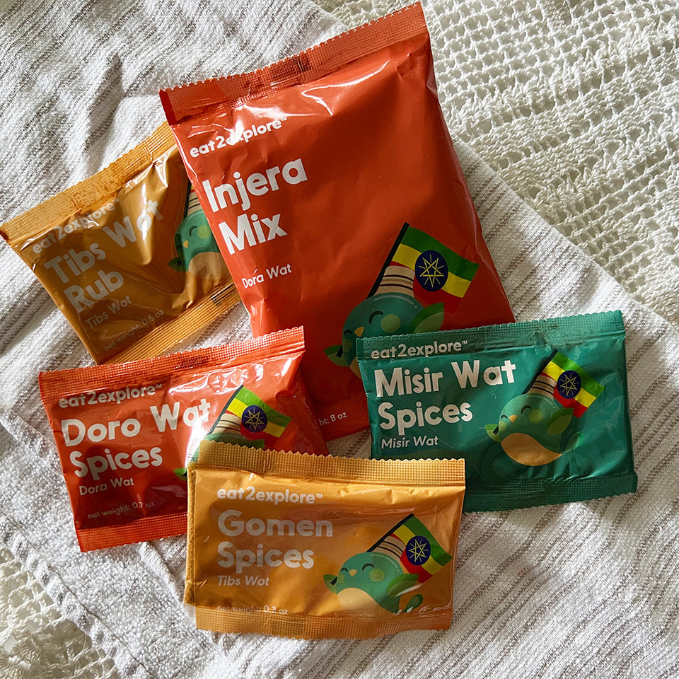 Ethiopian spice mix packets on textured cloth background.