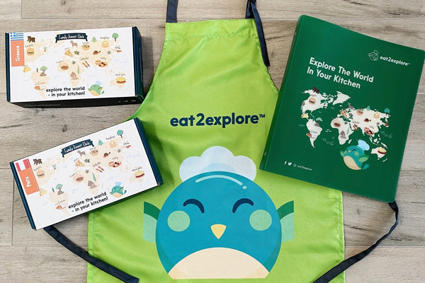 eat2explore kids apron with Greece & Peru cooking kits and eat2explore folder