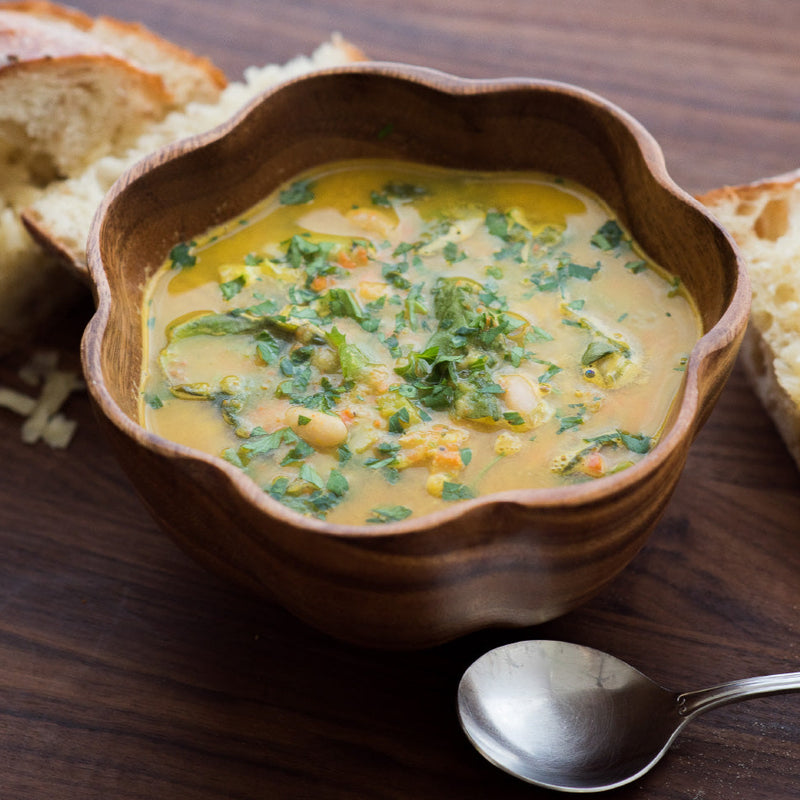 vegetable soup with bread on wooden table