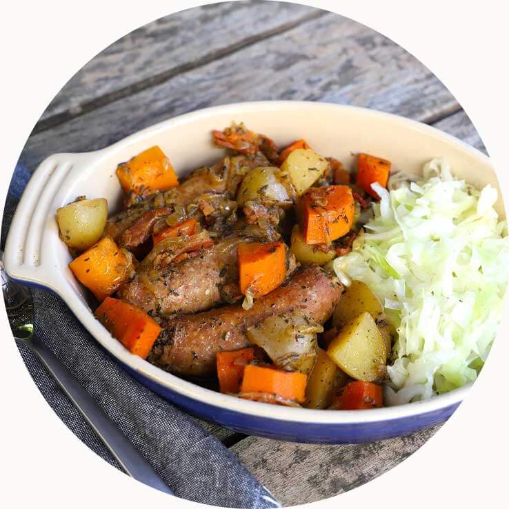 Dublin Coddle in a serving dish with sliced cabbage